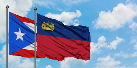 Puerto Rico and Liechtenstein flag waving in the wind against white cloudy blue sky together. Diplomacy concept, international relations.