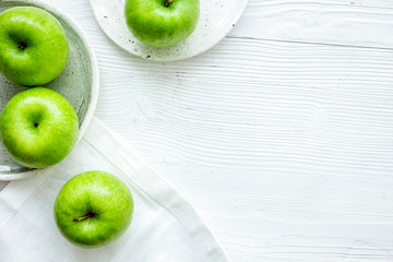 Healthy green food with apples on plates white background top view mock up