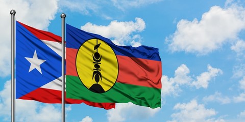 Puerto Rico and New Caledonia flag waving in the wind against white cloudy blue sky together. Diplomacy concept, international relations.