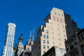 Fototapeta na wymiar Looking up at Old and Modern Buildings and Skyscrapers in Midtown Manhattan