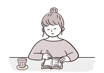 机でノートに書く女性