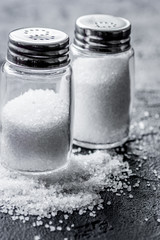 salt in bottle for spices set dark background closeup