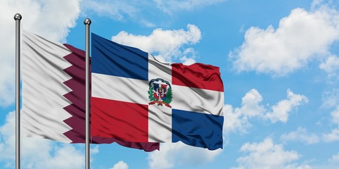 Qatar and Dominican Republic flag waving in the wind against white cloudy blue sky together. Diplomacy concept, international relations.