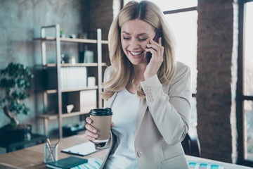 Photo of beautiful blond business lady chief holding telephone speaking with aged retired mom little corporate break drink hot coffee to-go formalwear blazer modern office