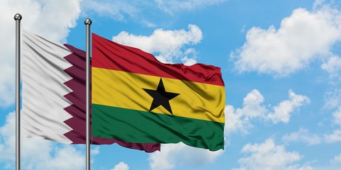 Qatar and Ghana flag waving in the wind against white cloudy blue sky together. Diplomacy concept, international relations.
