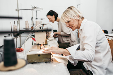 Two professional designers working in fashion studio. Creative people concept.