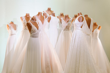 various beautiful wedding dresses as a background