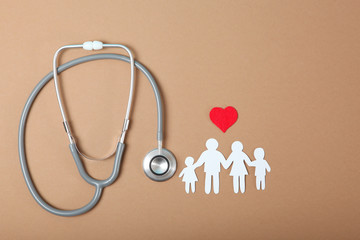 stethoscope and heart on a colored background top view. Family medicine