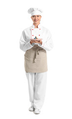 Female confectioner with tasty dessert on white background