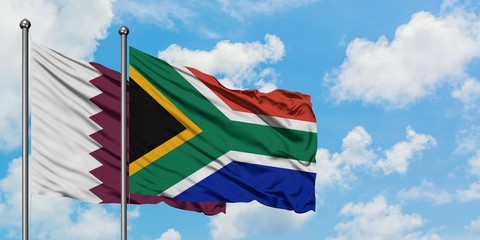 Qatar and South Africa flag waving in the wind against white cloudy blue sky together. Diplomacy concept, international relations.