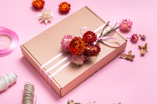 Cardboard Gift Box Decorated With Dried Flowers On Pink Background