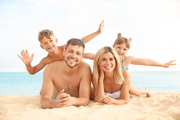 Portrait of happy family on sea beach