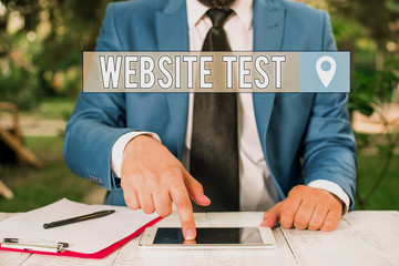 Writing note showing Website Test. Business concept for test the websites or web applications for potential bugs Businessman with pointing finger in front of him