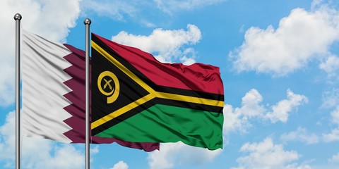 Qatar and Vanuatu flag waving in the wind against white cloudy blue sky together. Diplomacy concept, international relations.