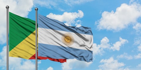 Republic Of The Congo and Argentina flag waving in the wind against white cloudy blue sky together. Diplomacy concept, international relations.