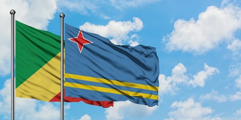 Republic Of The Congo and Aruba flag waving in the wind against white cloudy blue sky together. Diplomacy concept, international relations.