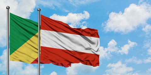 Republic Of The Congo and Austria flag waving in the wind against white cloudy blue sky together. Diplomacy concept, international relations.