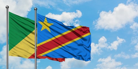 Republic Of The Congo and Congo flag waving in the wind against white cloudy blue sky together. Diplomacy concept, international relations.