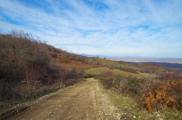 Scenic slope and empty dirt road. Nature and travel. Russia, North Caucasus, Dagestan, Tabasaransky District