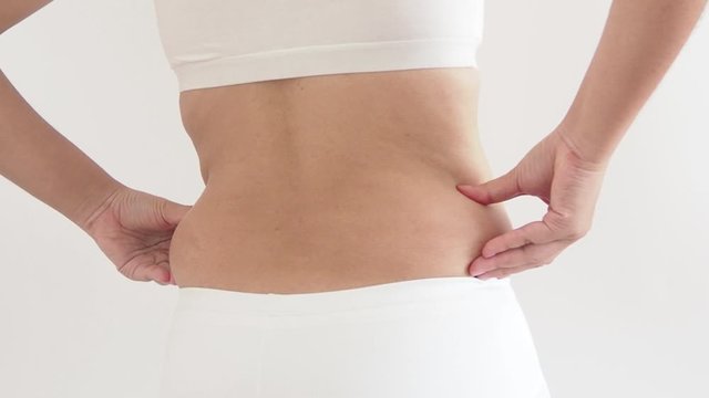 cellulite in woman and she grabbing her hip cause of fatty from weight and loss of collagen use for body firming gel or cream product or liposuction concept