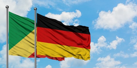 Republic Of The Congo and Germany flag waving in the wind against white cloudy blue sky together. Diplomacy concept, international relations.
