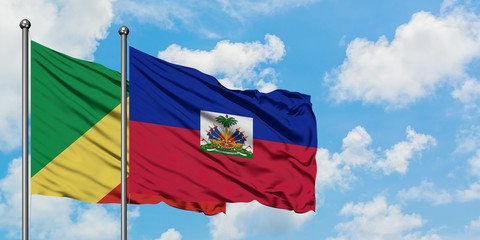 Republic Of The Congo and Haiti flag waving in the wind against white cloudy blue sky together. Diplomacy concept, international relations.