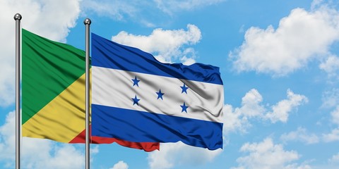 Republic Of The Congo and Honduras flag waving in the wind against white cloudy blue sky together. Diplomacy concept, international relations.