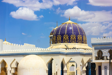 Naklejka premium Mosaic roofs of minorets in Egypt and white clouds against the blue sky