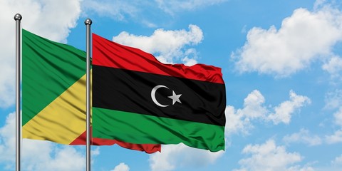 Republic Of The Congo and Libya flag waving in the wind against white cloudy blue sky together. Diplomacy concept, international relations.