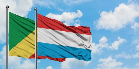 Republic Of The Congo and Luxembourg flag waving in the wind against white cloudy blue sky together. Diplomacy concept, international relations.
