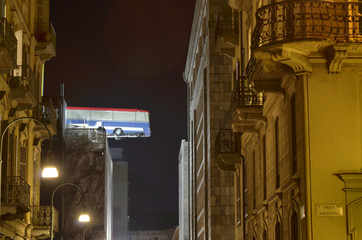 Turin, Piemonte, Italy. November 2019. A bus poised on the roof of a building. You can see the bus...
