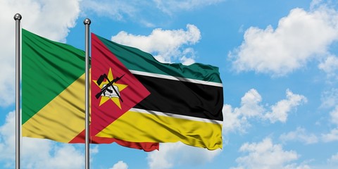 Republic Of The Congo and Mozambique flag waving in the wind against white cloudy blue sky together. Diplomacy concept, international relations.
