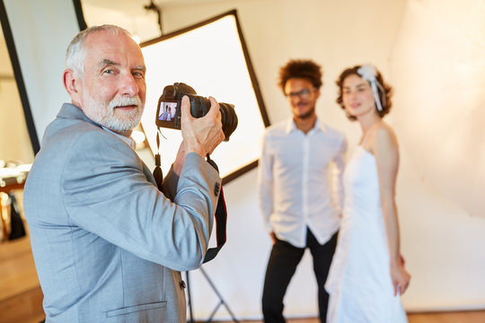 Wedding photographer takes pictures of the bride and groom