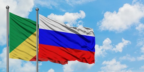 Republic Of The Congo and Russia flag waving in the wind against white cloudy blue sky together. Diplomacy concept, international relations.