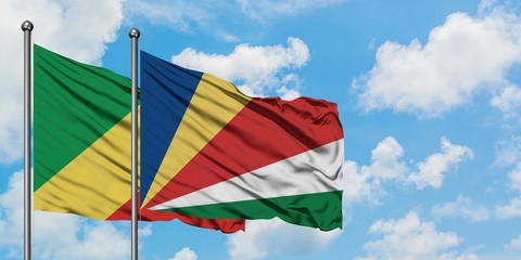 Republic Of The Congo and Seychelles flag waving in the wind against white cloudy blue sky together. Diplomacy concept, international relations.