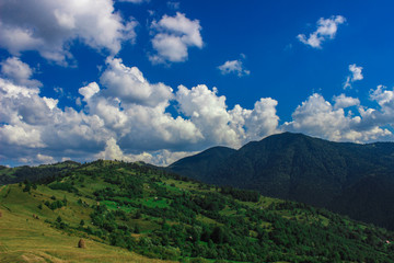 Fototapeta na wymiar Mountain valley with white clouds