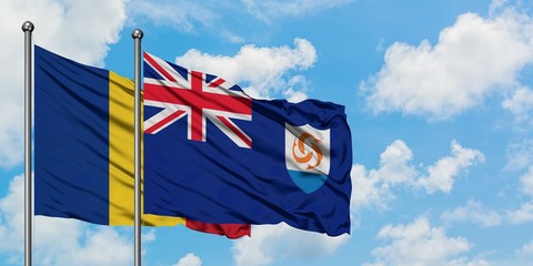 Romania and Anguilla flag waving in the wind against white cloudy blue sky together. Diplomacy...