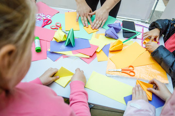 Children make paper origami