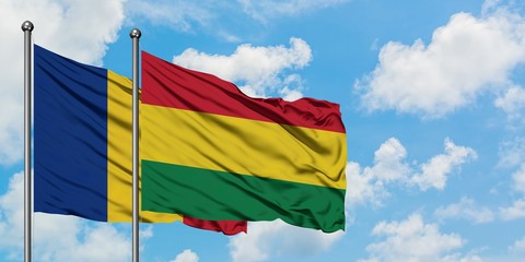 Romania and Bolivia flag waving in the wind against white cloudy blue sky together. Diplomacy concept, international relations.