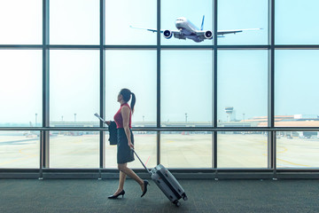 Business asian women leave luggage and meet at the airport to fly to see work in foreign countries....