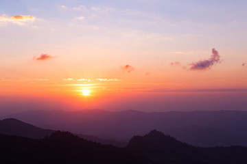 Colorful pastel color clear sky with cloud and silhouette mountains at twilight time before sunset, take photo from top of mountain in Thailand