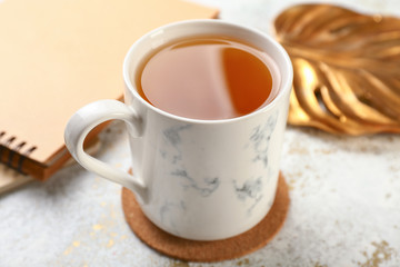 Cup of hot tea on white background