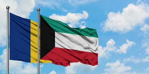 Romania and Kuwait flag waving in the wind against white cloudy blue sky together. Diplomacy concept, international relations.