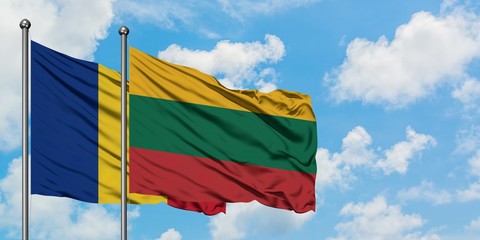 Romania and Lithuania flag waving in the wind against white cloudy blue sky together. Diplomacy...