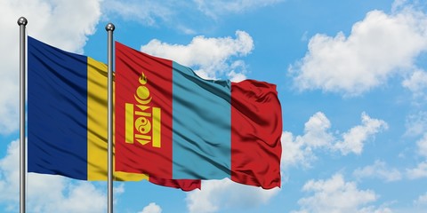 Romania and Mongolia flag waving in the wind against white cloudy blue sky together. Diplomacy...