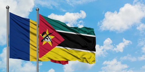 Romania and Mozambique flag waving in the wind against white cloudy blue sky together. Diplomacy concept, international relations.