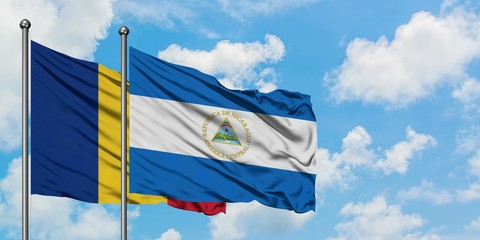 Romania and Nicaragua flag waving in the wind against white cloudy blue sky together. Diplomacy concept, international relations.