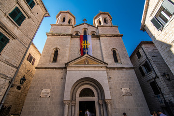 Fototapeta na wymiar KOTOR, MONTENEGRO - JULY 2019: View on a small square in old town in Kotor, Montenegro. Kotor is town on coast of Montenegro and located on the Bay of Kotor