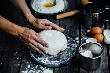 woman hands mixing dough on table