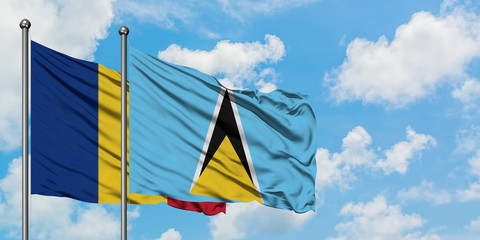 Romania and Saint Lucia flag waving in the wind against white cloudy blue sky together. Diplomacy concept, international relations.